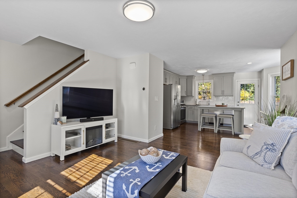 45 Riley Road, Unit 45 Tyngsborough, MA 01879 - Photo 6 of 42 a living room with furniture and a flat screen tv