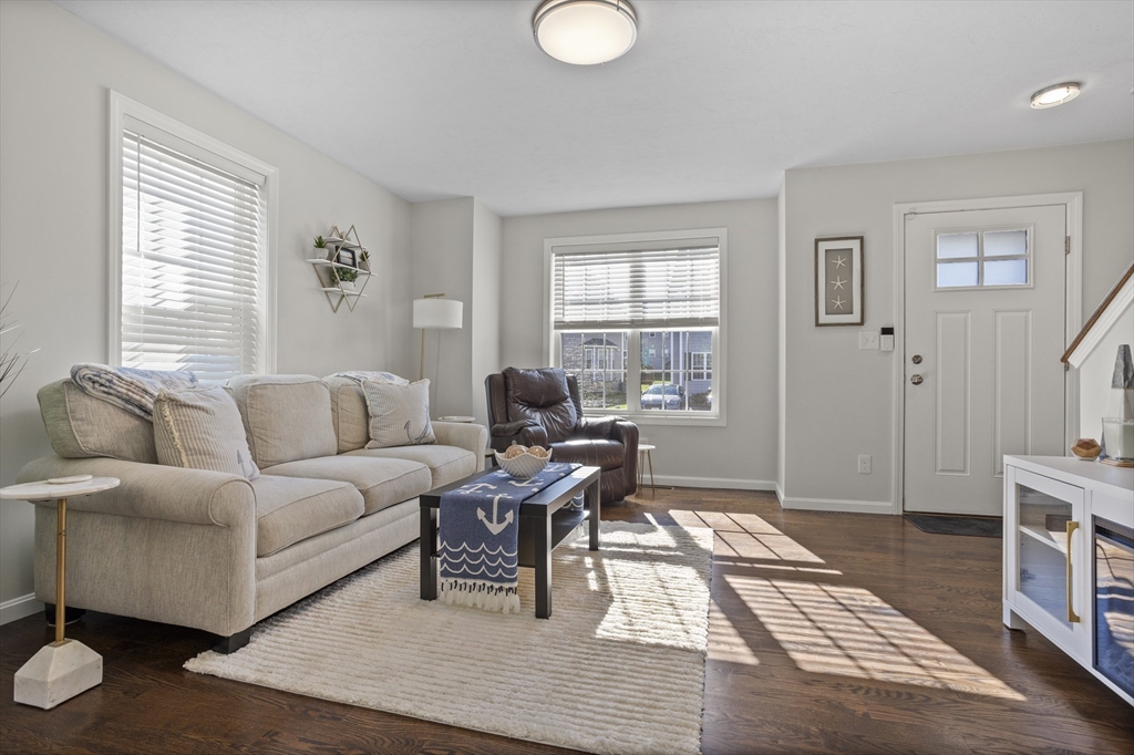45 Riley Road, Unit 45 Tyngsborough, MA 01879 - Photo 7 of 42 a living room with furniture a rug and a window