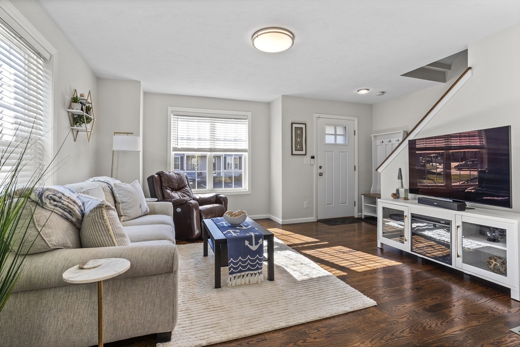 45 Riley Road, Unit 45 Tyngsborough, MA 01879 - Photo 8 of 42 a living room with furniture and a flat screen tv