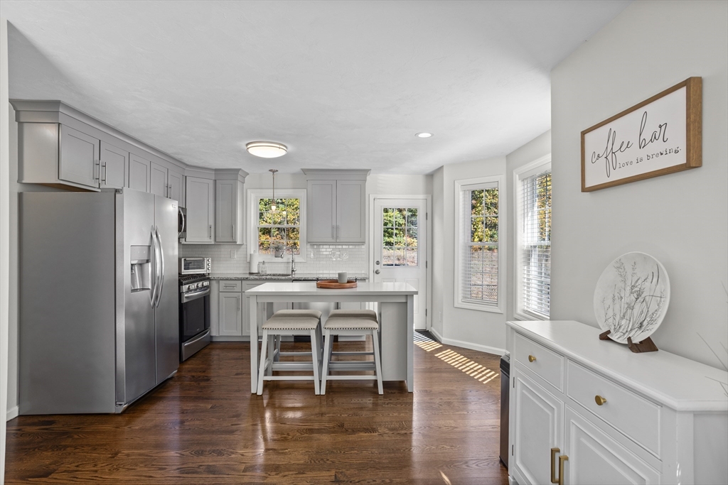 45 Riley Road, Unit 45 Tyngsborough, MA 01879 - Photo 9 of 42 a kitchen with stainless steel appliances granite countertop a refrigerator and a stove top oven