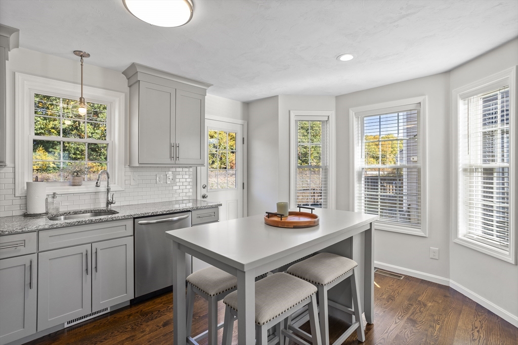 45 Riley Road, Unit 45 Tyngsborough, MA 01879 - Photo 10 of 42 a kitchen with a table chairs sink and cabinets