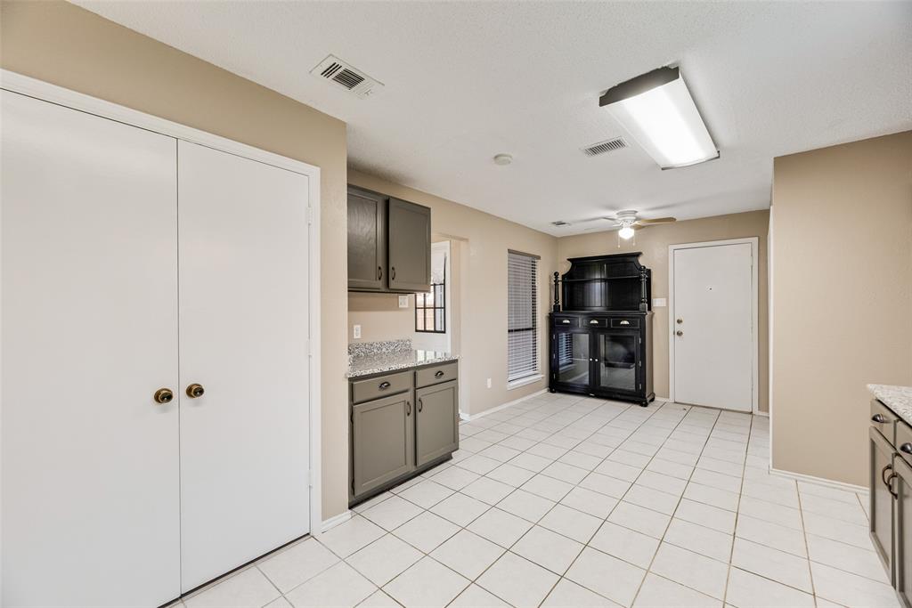 7805 Swiss Way Rowlett, TX 75089 - Photo 13 of 32 a large white kitchen with cabinets