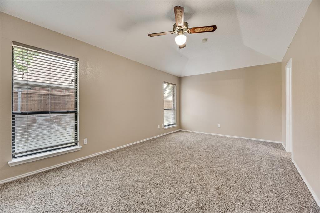 7805 Swiss Way Rowlett, TX 75089 - Photo 18 of 32 an empty room with windows and fan