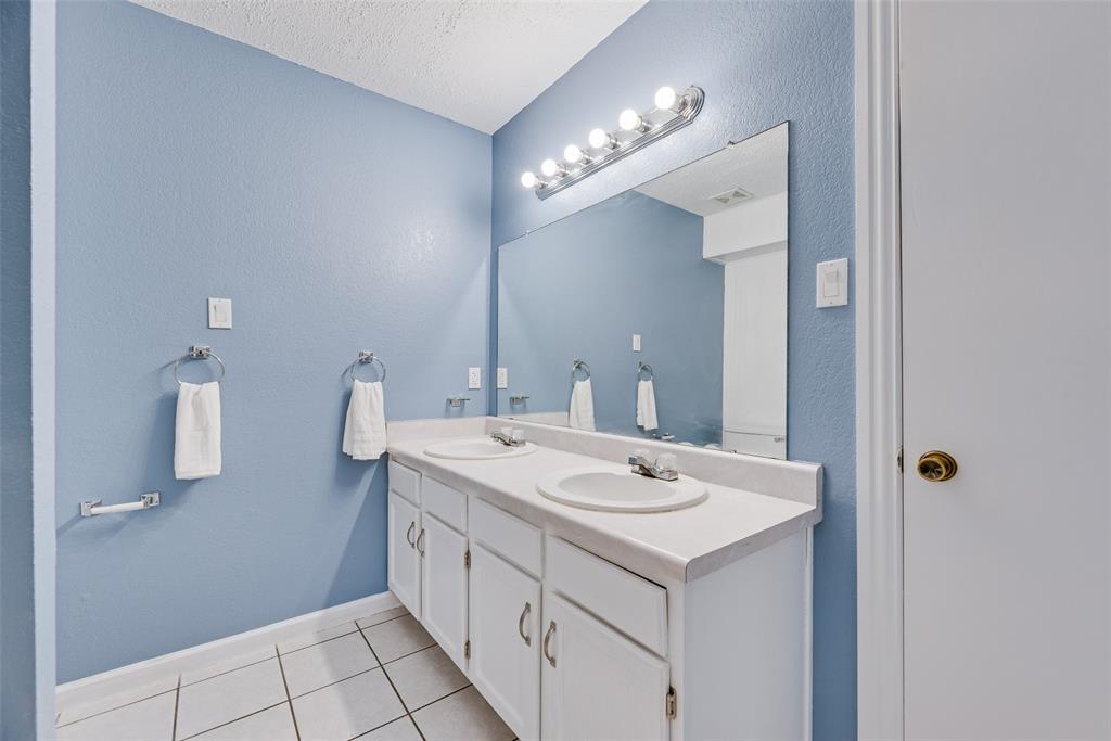 7805 Swiss Way Rowlett, TX 75089 - Photo 20 of 32 a bathroom with a sink and a mirror