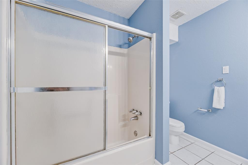7805 Swiss Way Rowlett, TX 75089 - Photo 21 of 32 a bathroom with a shower and a toilet
