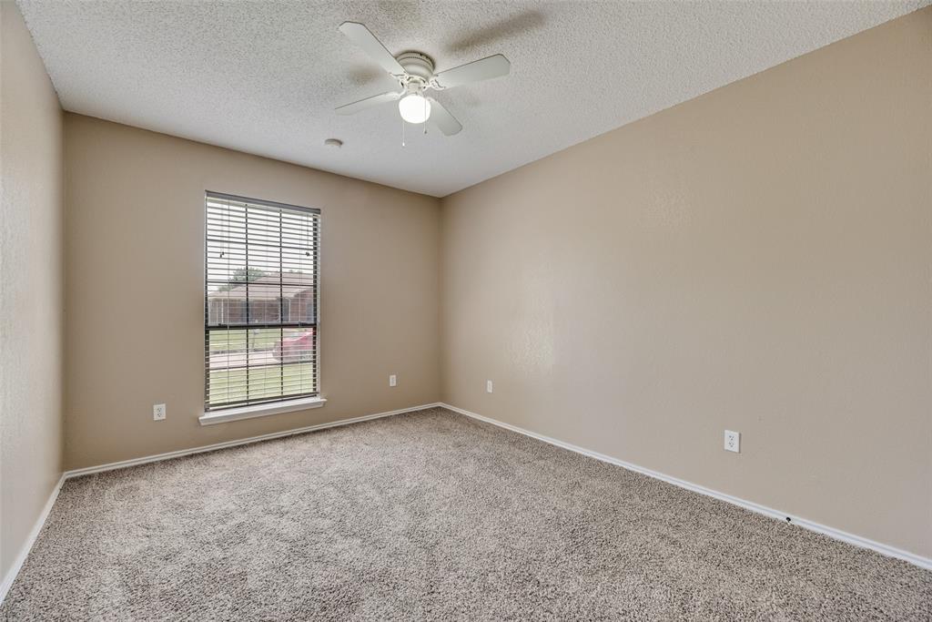 7805 Swiss Way Rowlett, TX 75089 - Photo 22 of 32 an empty room with windows and ceiling fan
