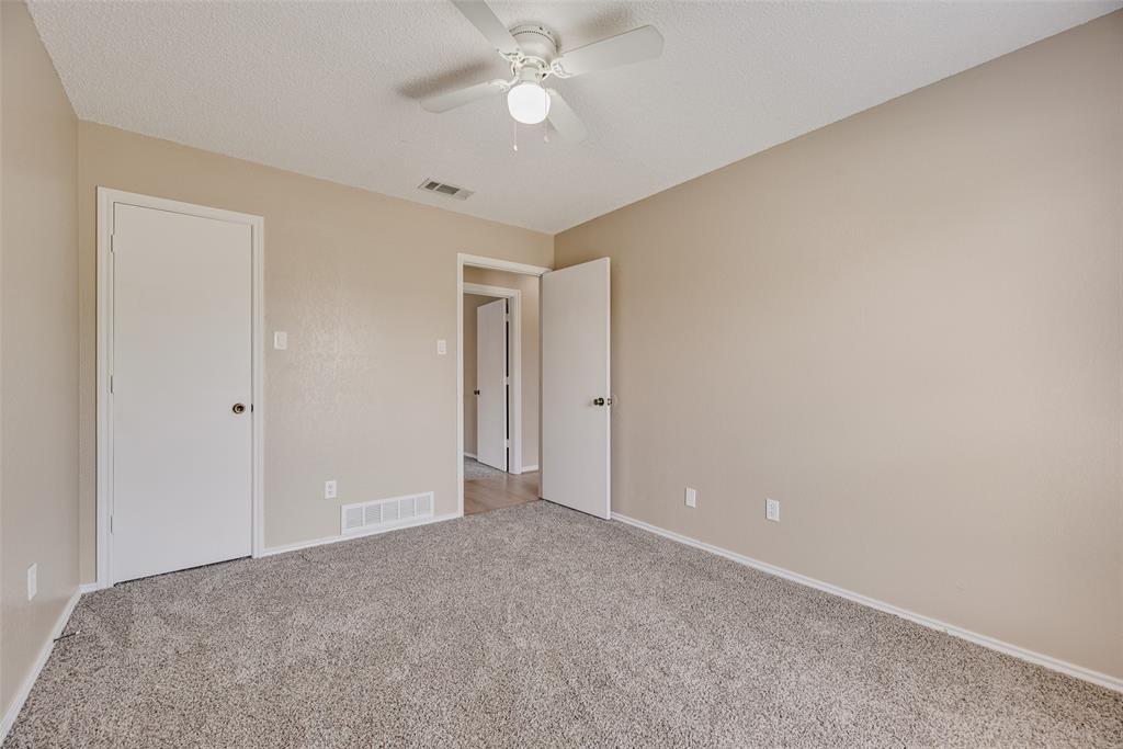 7805 Swiss Way Rowlett, TX 75089 - Photo 23 of 32 a view of an empty room with a ceiling fan
