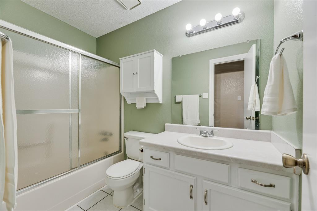7805 Swiss Way Rowlett, TX 75089 - Photo 26 of 32 a bathroom with a sink a toilet and shower