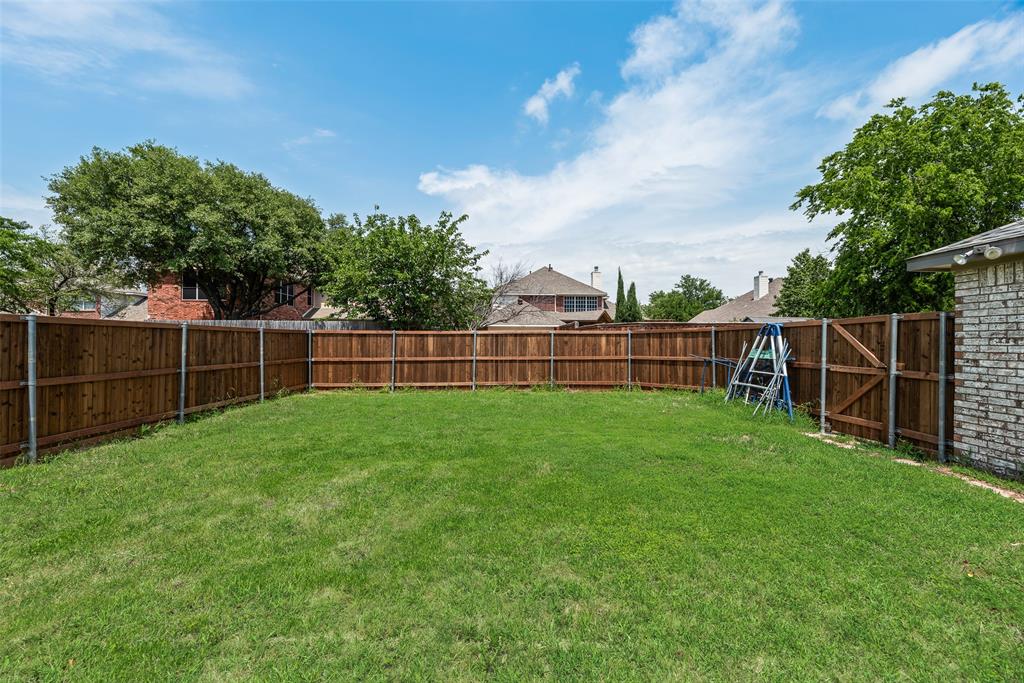 7805 Swiss Way Rowlett, TX 75089 - Photo 30 of 32 a view of a yard with a wooden fence