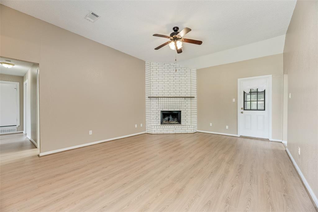 7805 Swiss Way Rowlett, TX 75089 - Photo 8 of 32 a view of empty room with wooden floor and fan