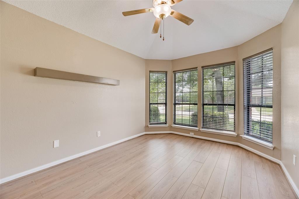 7805 Swiss Way Rowlett, TX 75089 - Photo 10 of 32 a view of an empty room with wooden floor and a window