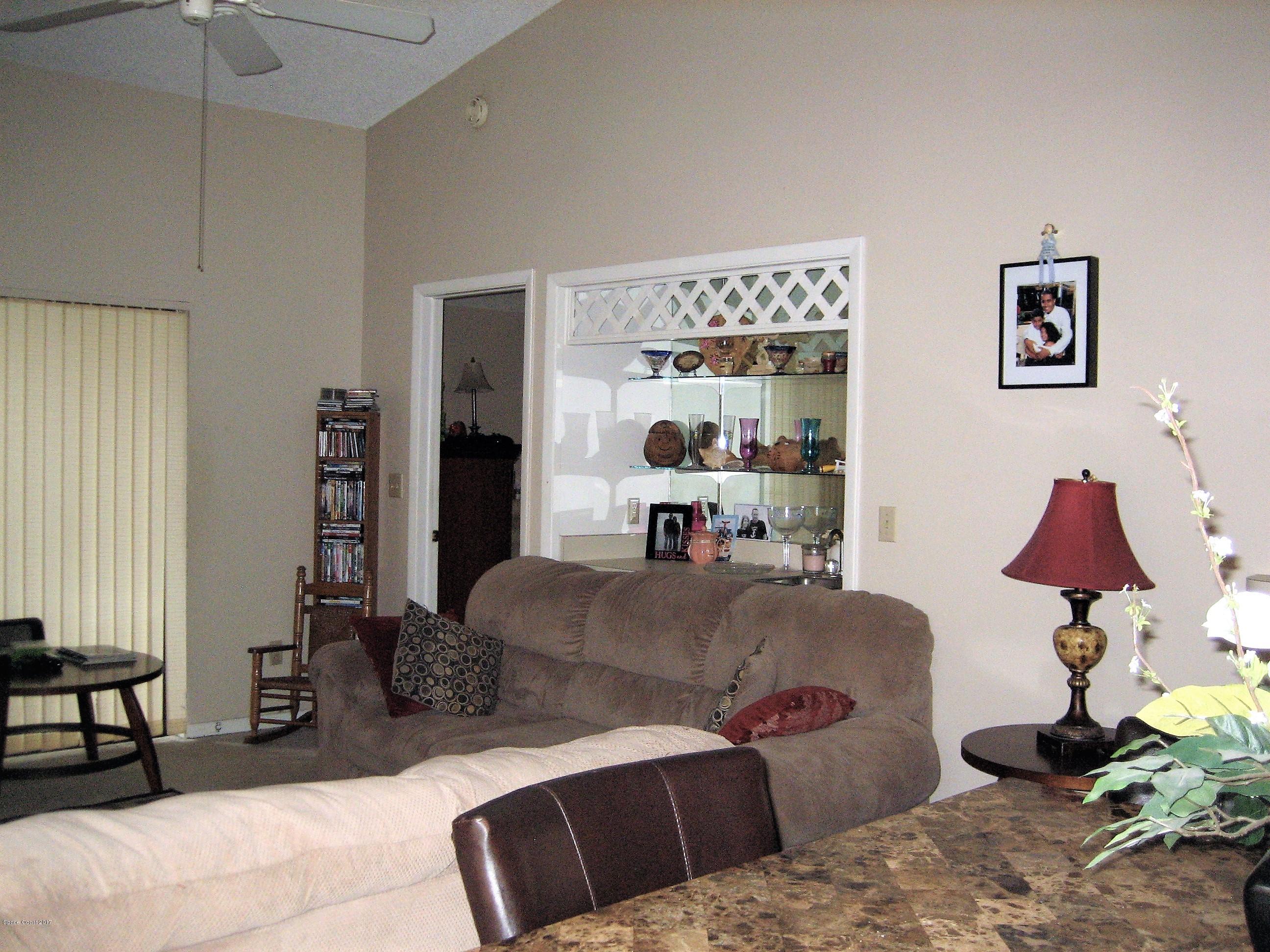 365 Myrtlewood Road Melbourne, FL 32940 - Photo 4 of 8 a living room with a couch and a window