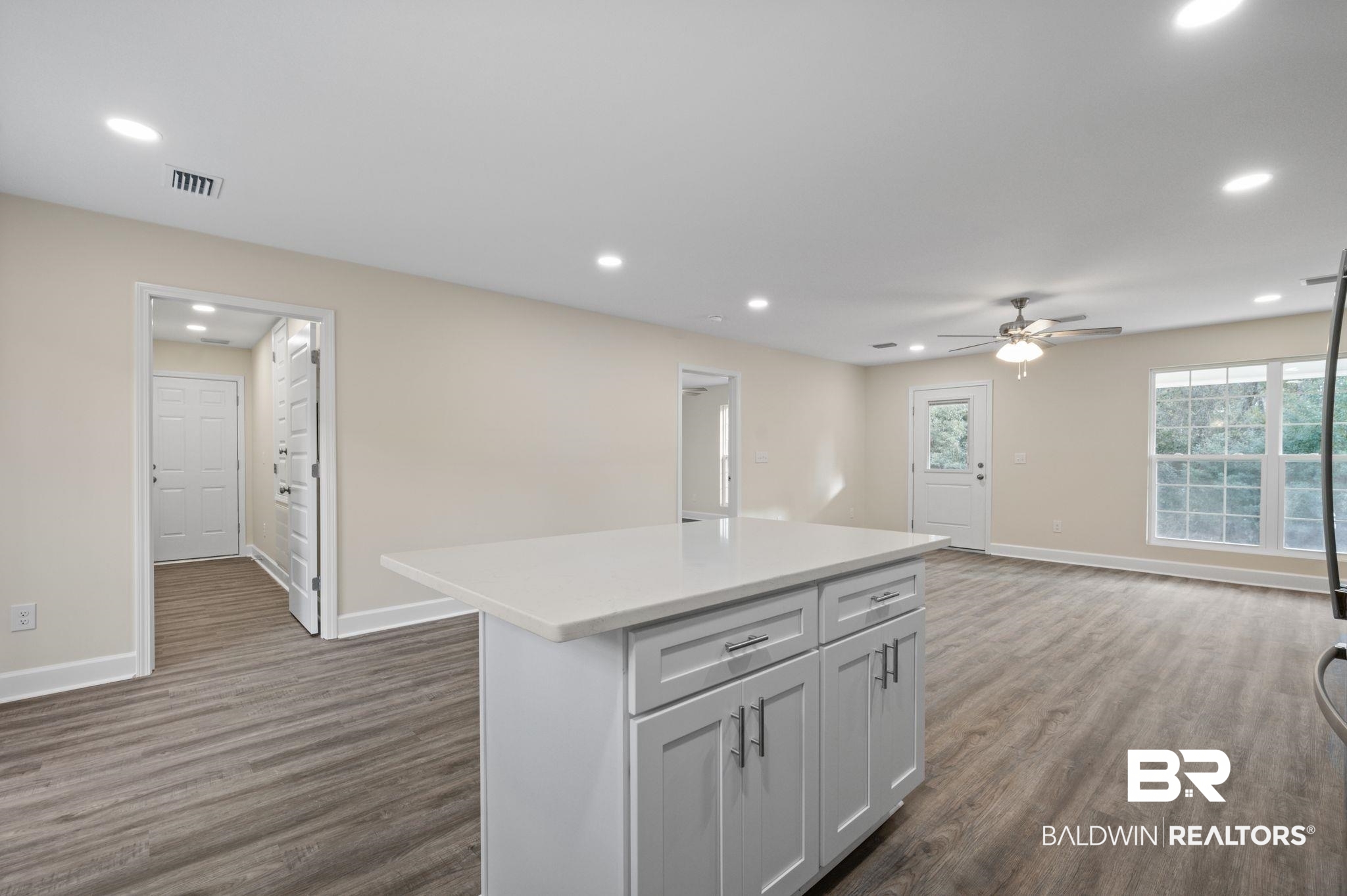 1473 Pollard Road Daphne, AL 36526 - Photo 18 of 32 Kitchen with dark hardwood / wood-style flooring, a center island, and ceiling fan