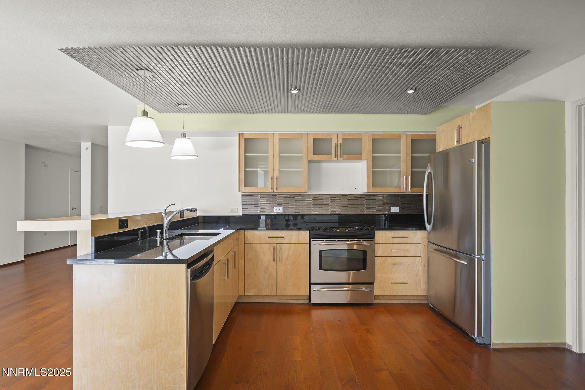 255 North Sierra Street, Unit 1419 Reno, NV 89501 - Photo 11 of 40 a kitchen with kitchen island granite countertop a sink cabinets and stainless steel appliances