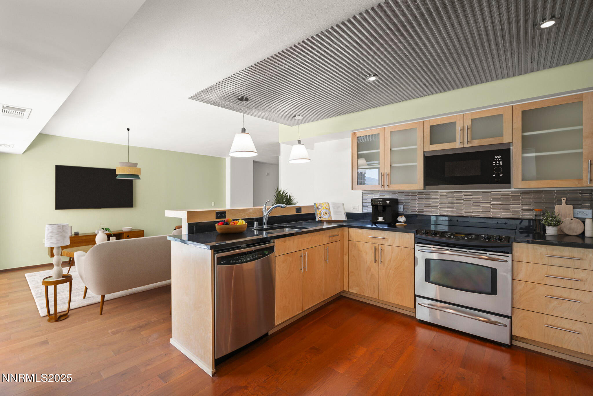 255 North Sierra Street, Unit 1419 Reno, NV 89501 - Photo 12 of 40 a kitchen with stainless steel appliances kitchen island granite countertop a stove and a sink