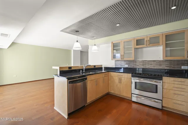 a kitchen with stainless steel appliances granite countertop a stove and a sink