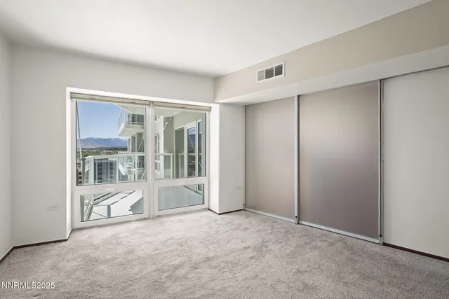 a view of an empty room with a fireplace