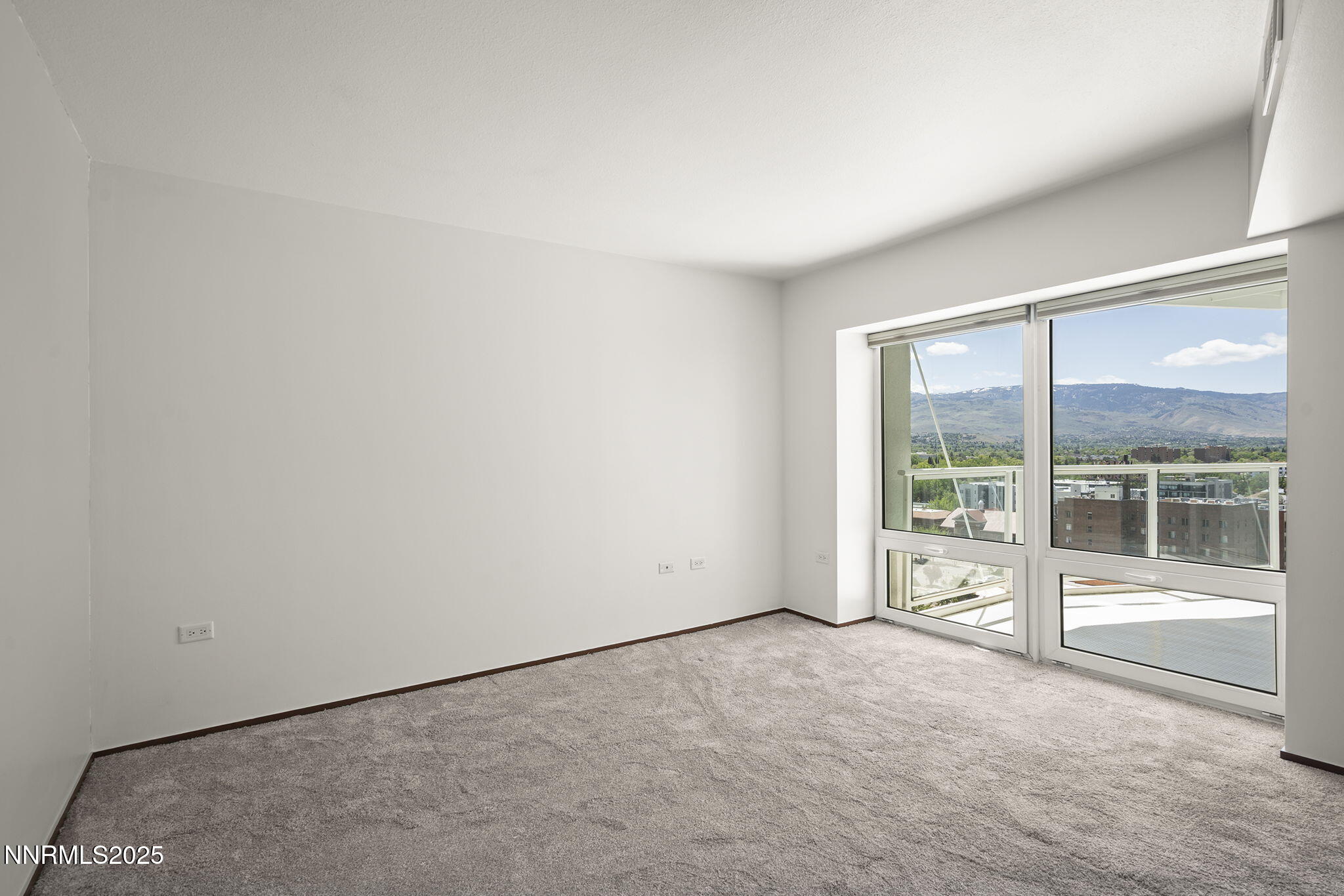 255 North Sierra Street, Unit 1419 Reno, NV 89501 - Photo 23 of 40 an empty room with floor to ceiling window and an outdoor view