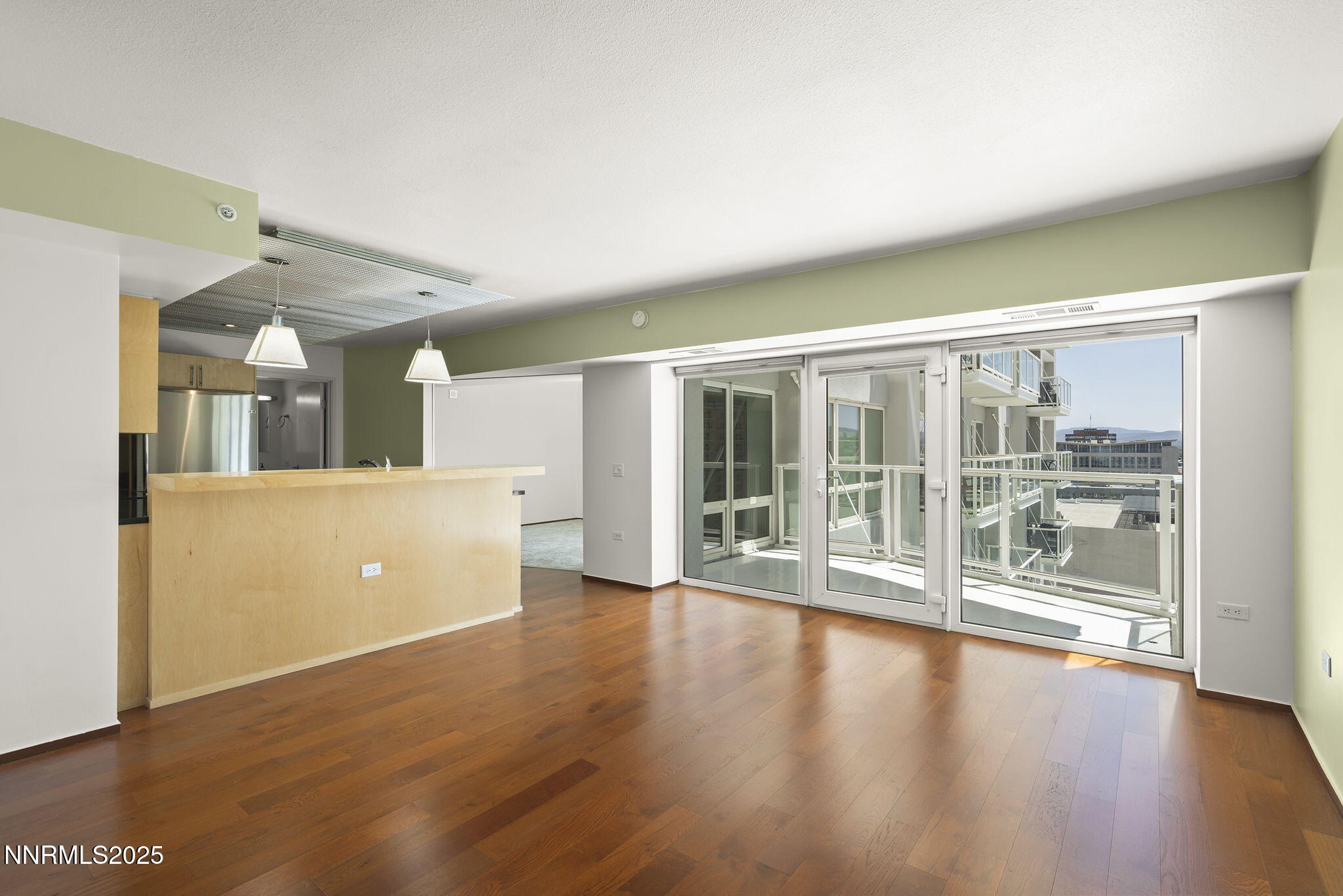 255 North Sierra Street, Unit 1419 Reno, NV 89501 - Photo 3 of 40 a view of a big room with wooden floor and windows