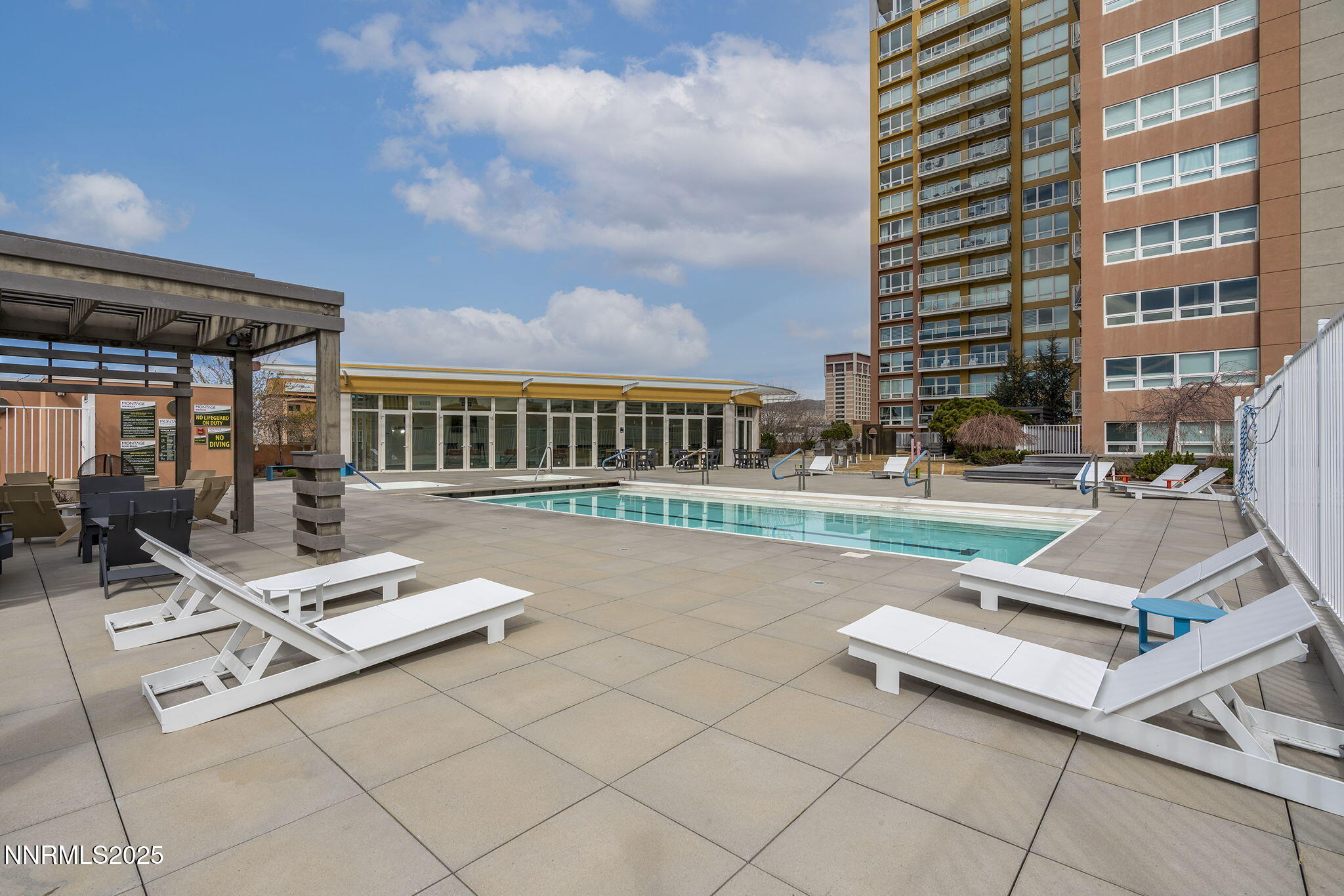 255 North Sierra Street, Unit 1419 Reno, NV 89501 - Photo 31 of 40 a view of pool with lawn chairs and wooden fence