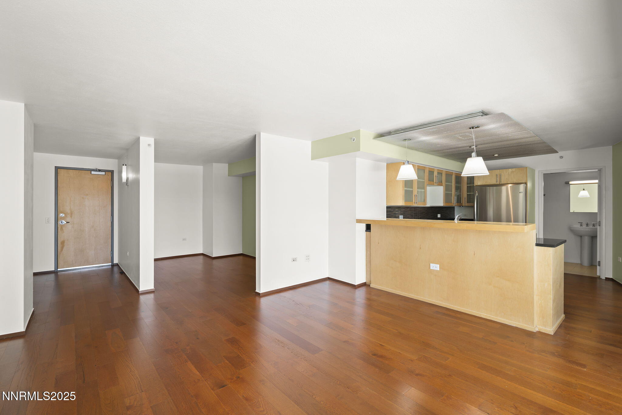 255 North Sierra Street, Unit 1419 Reno, NV 89501 - Photo 7 of 40 a view of a big room with wooden floor and a kitchen
