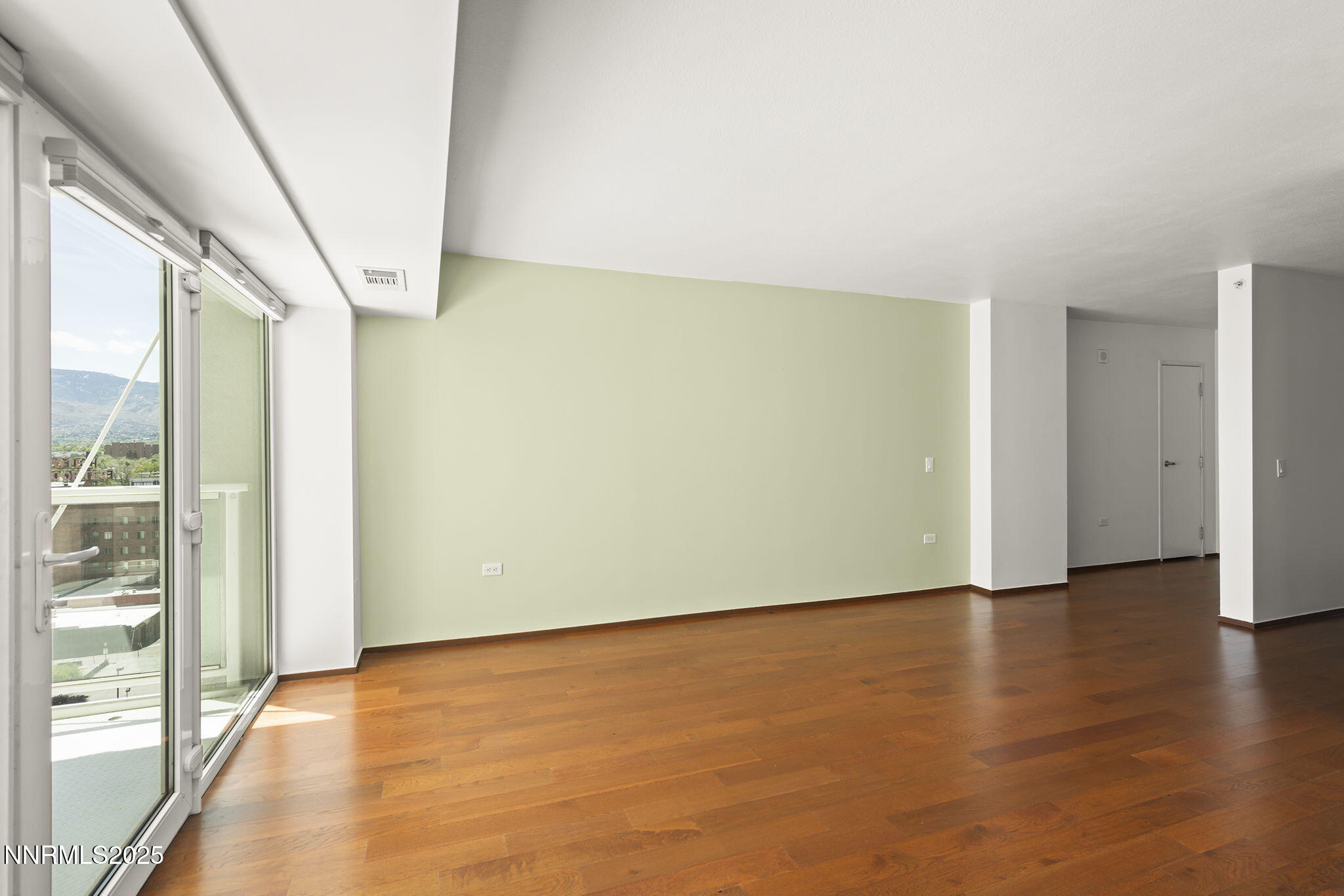 255 North Sierra Street, Unit 1419 Reno, NV 89501 - Photo 9 of 40 an empty room with wooden floor and windows