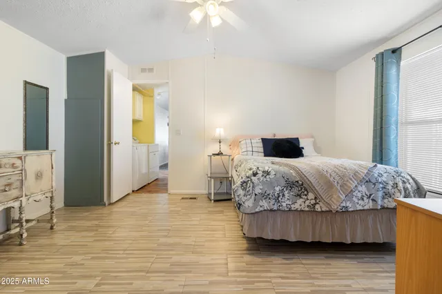 a bedroom with a bed and wooden floor
