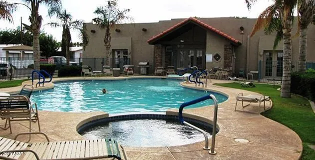a view of swimming pool with outdoor seating and plants