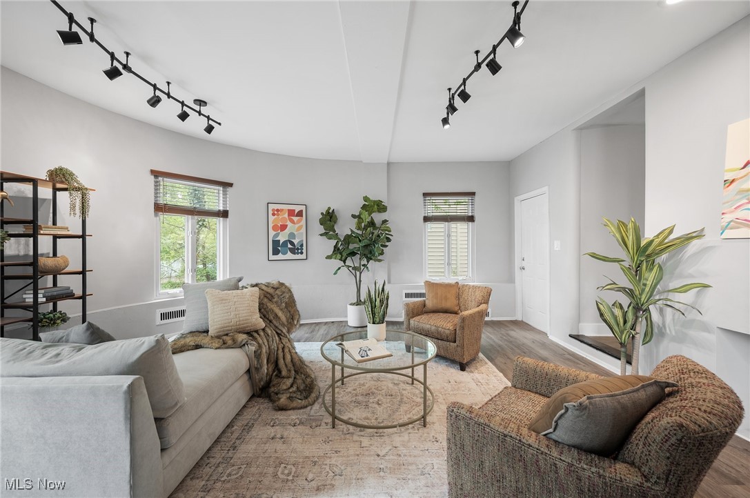 3045 Scarborough Road Cleveland, OH 44118 - Photo 11 of 42 Living room featuring track lighting, wood finished floors, and a healthy amount of sunlight