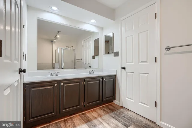 a spacious bathroom with a double vanity sink and a mirror