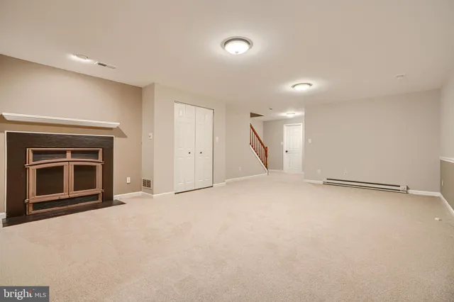 a view of an empty room with a fireplace