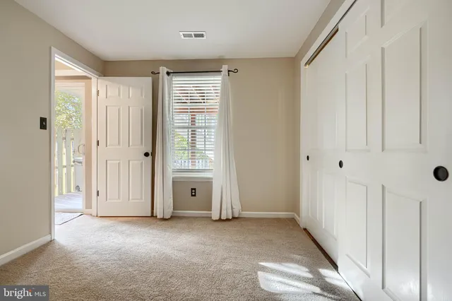 a view of a livingroom with an empty space and a window