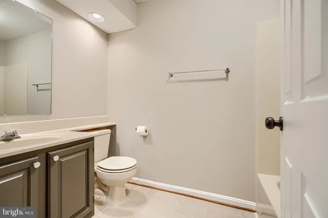 a bathroom with a toilet a sink and a window