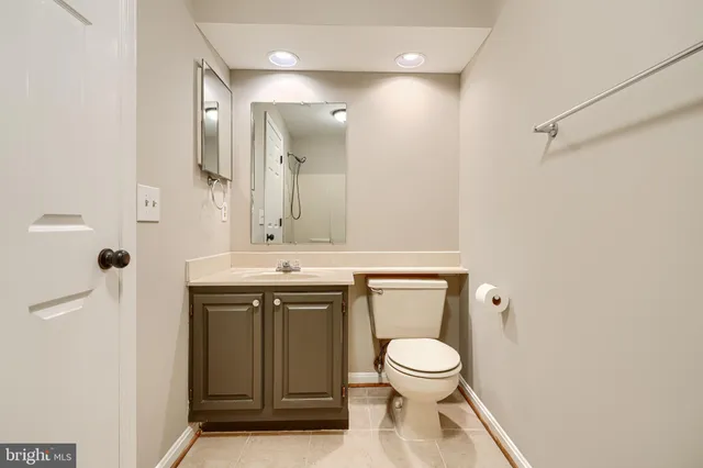 a bathroom with a toilet sink a mirror and shower