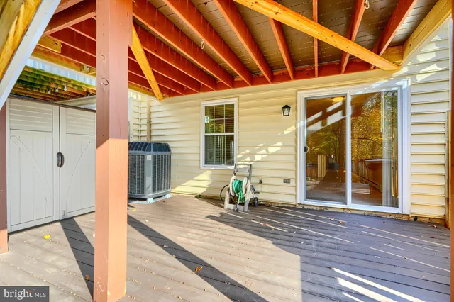 a porch with a table and chairs