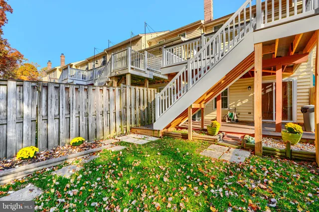 a view of a house with wooden fence