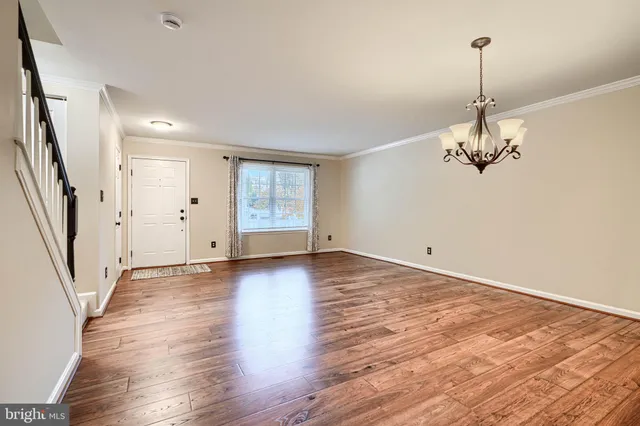 a view of a room with wooden floor and staircase