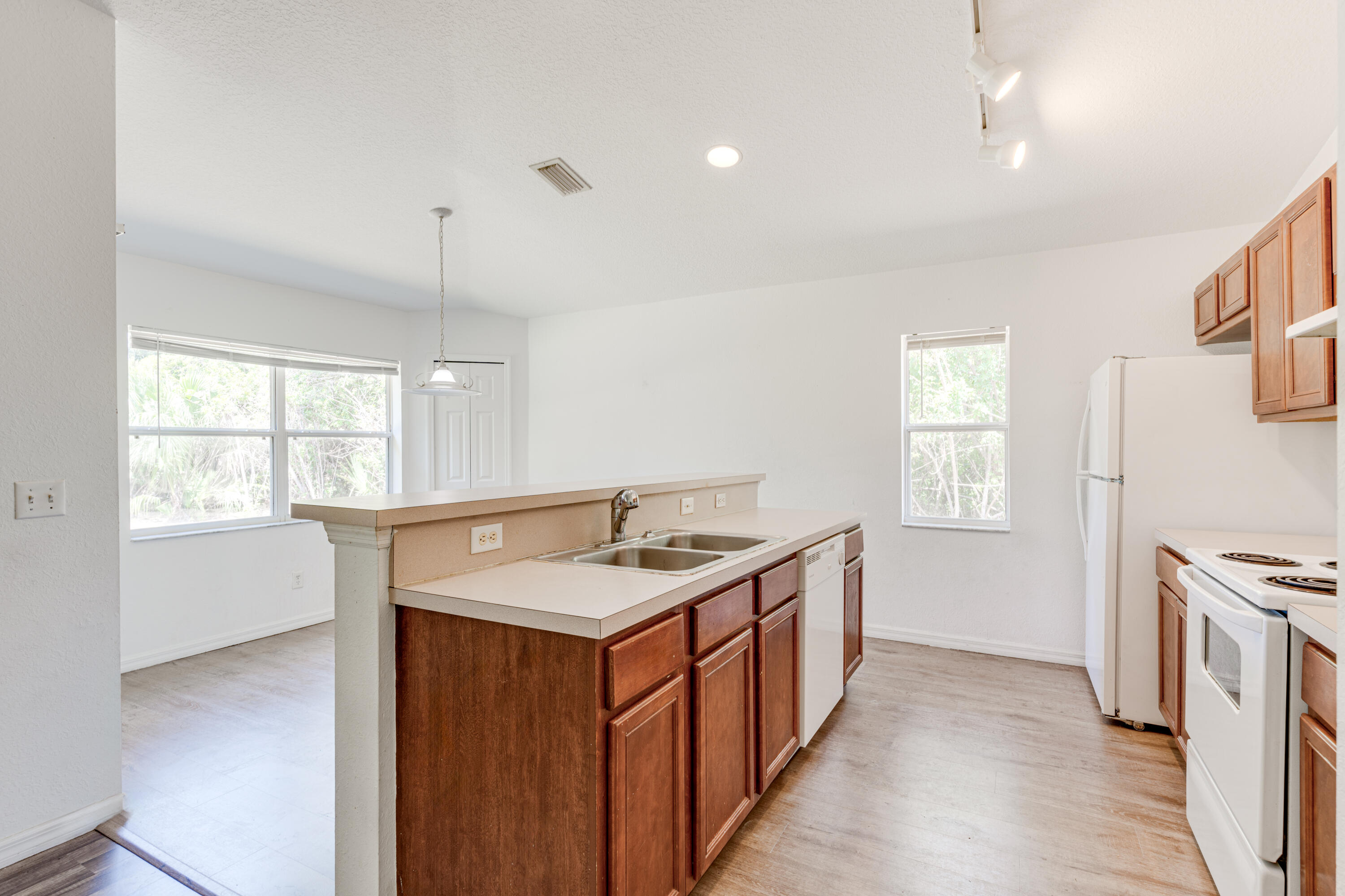 500 Topeka Road Southwest Palm Bay, FL 32908 - Photo 6 of 12 a kitchen with a sink stove and cabinets