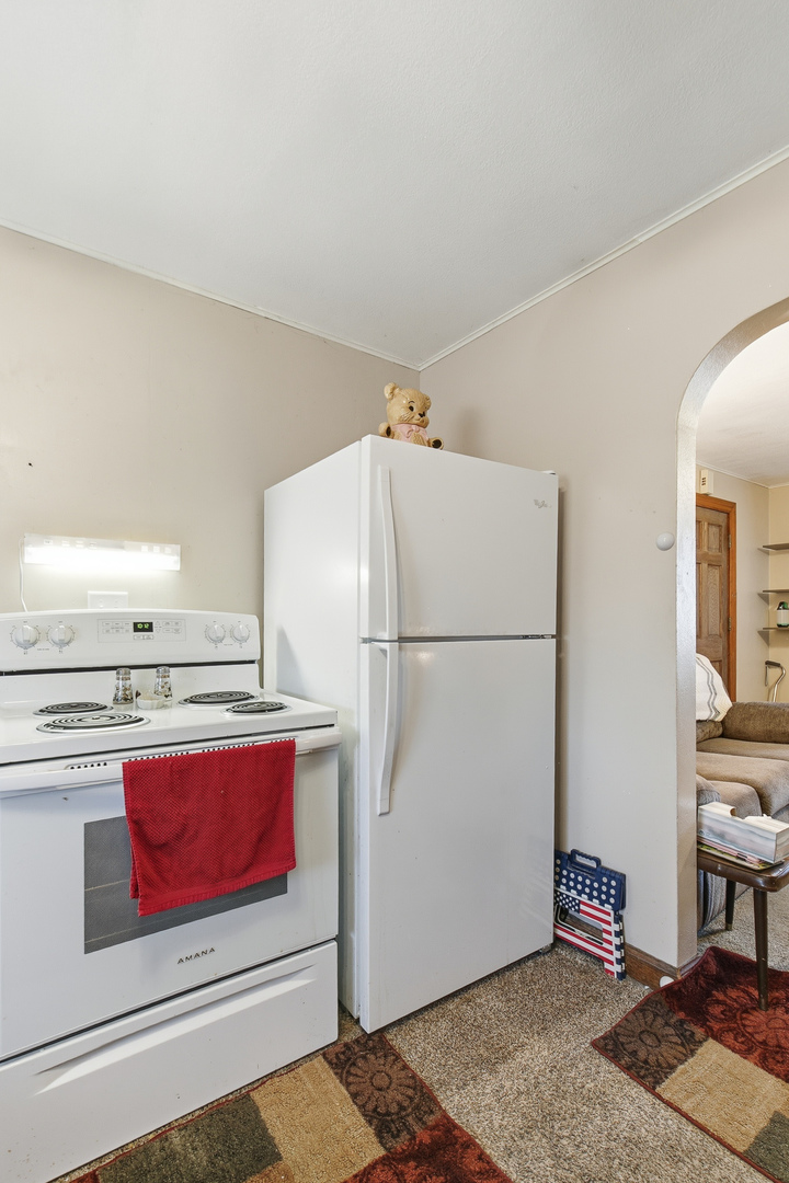 2400 47th Street Moline, IL 61265 - Photo 18 of 23 a kitchen with stainless steel appliances granite countertop a refrigerator sink stove and cabinets