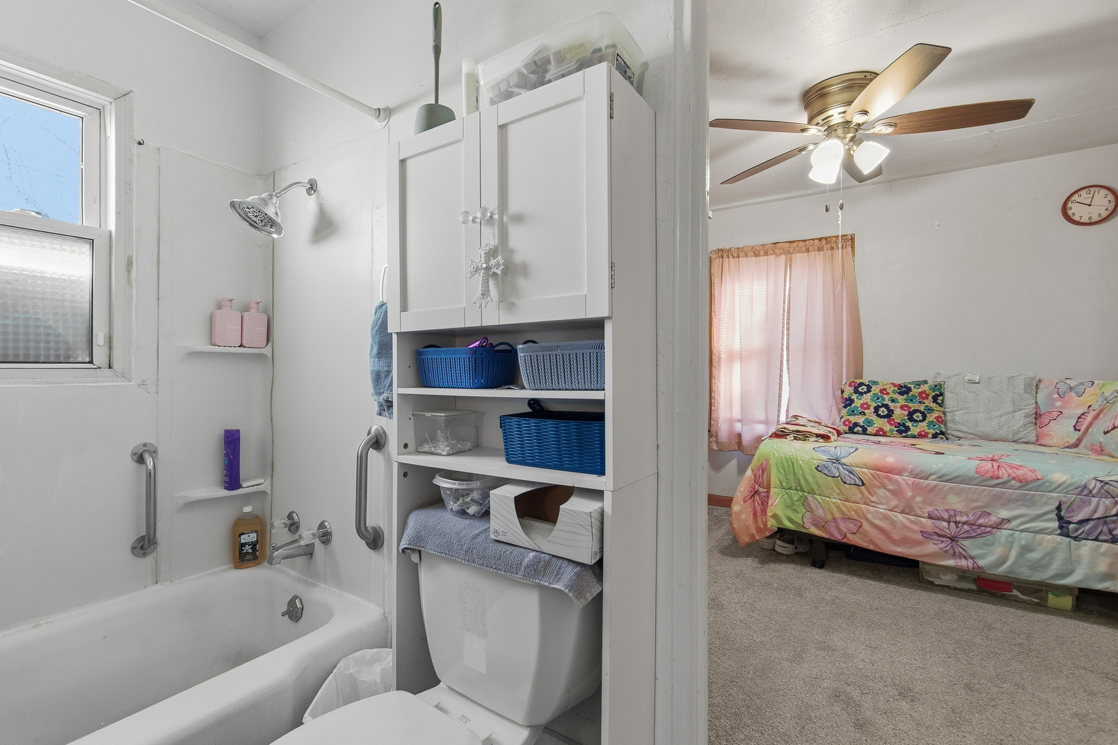 2400 47th Street Moline, IL 61265 - Photo 10 of 23 a bathroom with a bed mirror and a chandelier