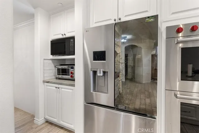 a view of a kitchen from a hallway