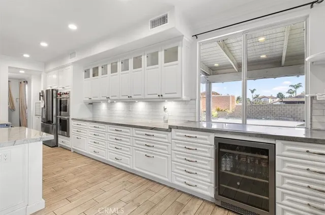 a kitchen with stainless steel appliances granite countertop a stove and a refrigerator