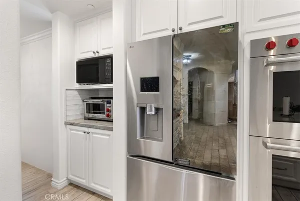 a kitchen with stainless steel appliances granite countertop a stove and a refrigerator