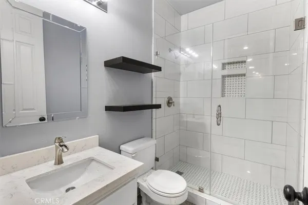a white toilet sitting next to a bath tub