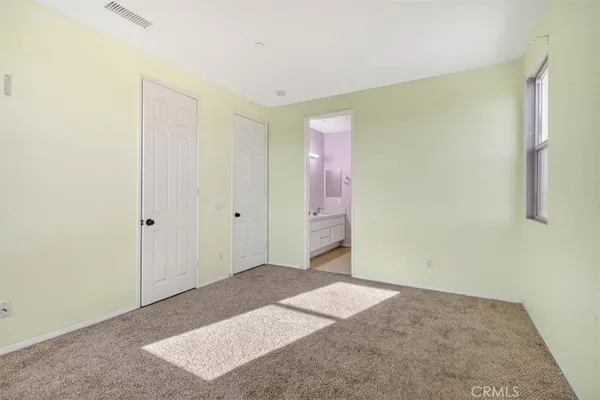 a bedroom with a large bed and large window