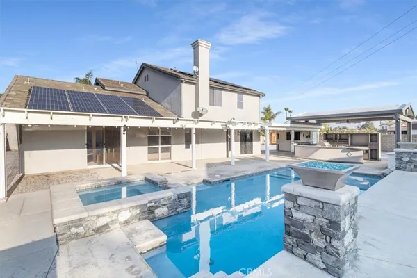 a view of swimming pool with outdoor seating and plants