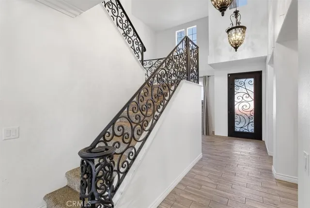 a view of a hallway with wooden floor and staircase