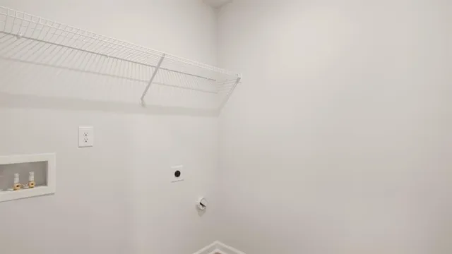 a backyard of a house with table and chairs under an umbrella