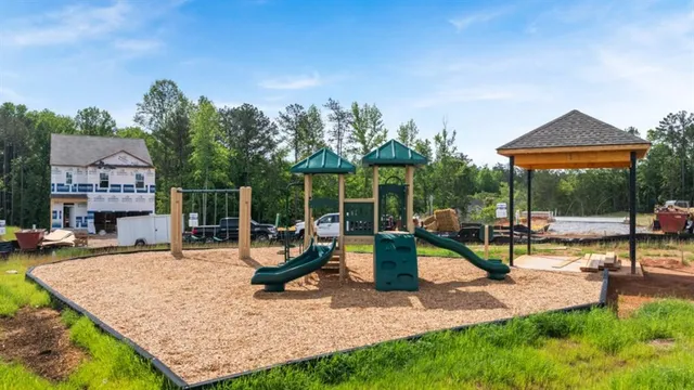a view of a swimming pool with a patio and a yard