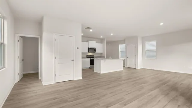 a kitchen with granite countertop white cabinets and stainless steel appliances